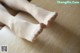 A pair of white stockings sitting on top of a wooden table.