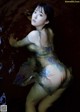 A woman in a blue dress is standing in the water.